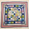 Small quilt with pink border and applique